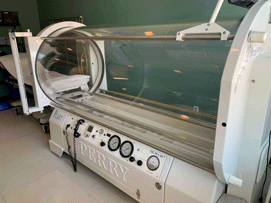 Hospital room with a bed, designed for Hyperbaric Oxygen Therapy in the Dallas Metro Area.