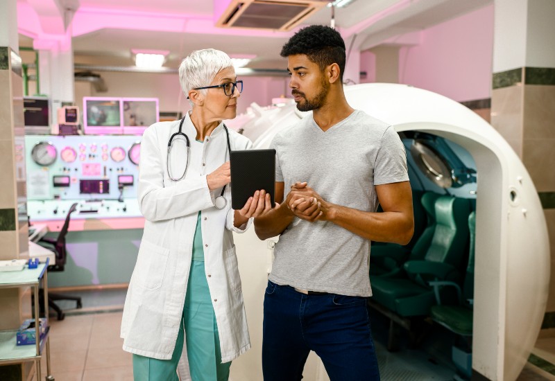 In the Dallas Metro Area, a man and a nurse discuss HBOT for sports injuries.