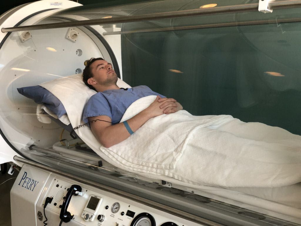 Patient receiving hyperbaric oxygen therapy, highlighting its benefits in 2025